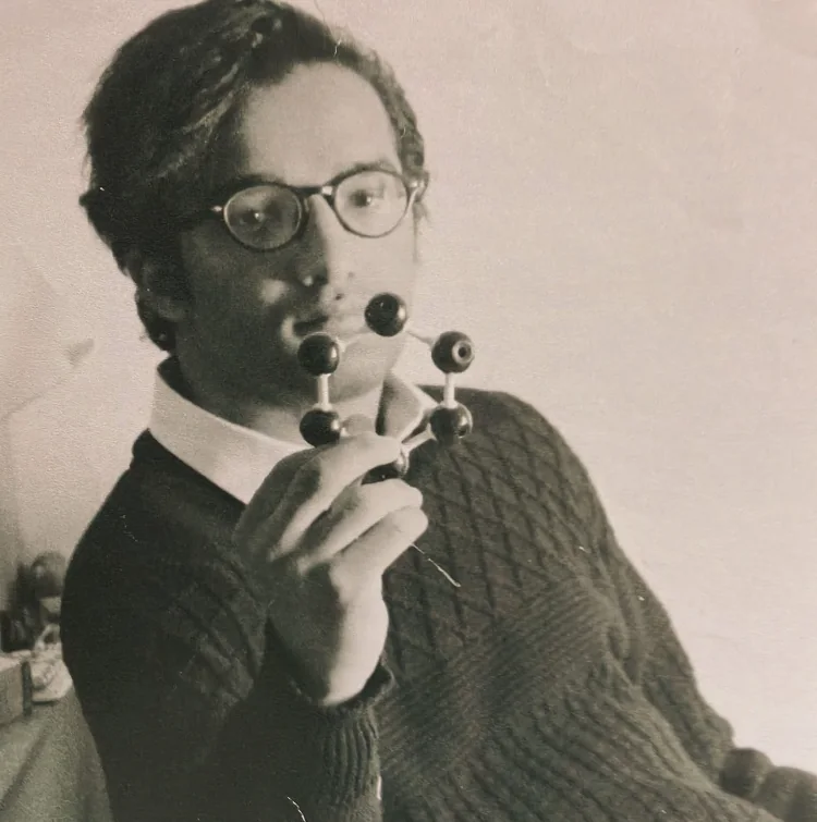 Young Mahmoud holding a six-membered ball-and-stick molecular model