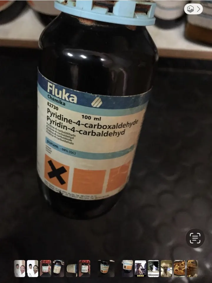 Front label of a Fluka Chemika bottle reading pyridine-4-carboxaldehyde, 100 mL