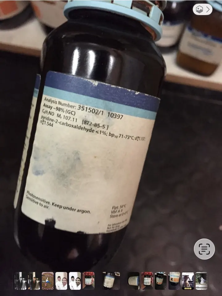Reverse label of the same pyridine-4-carboxaldehyde reagent bottle showing supplier analysis and storage advice