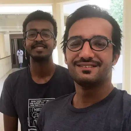 Abdelrahman Adel Mahmoud with Mahmoud Al-Ruweidi in matching chemistry-themed shirts