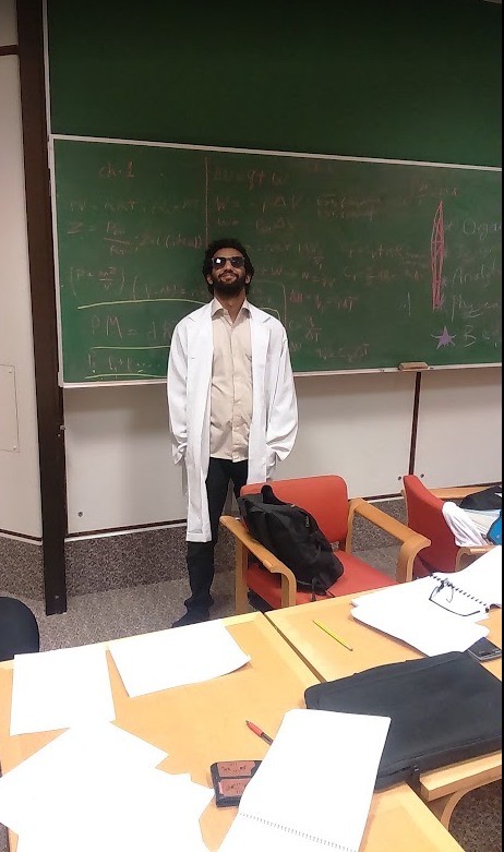 University-era photograph near a chalkboard