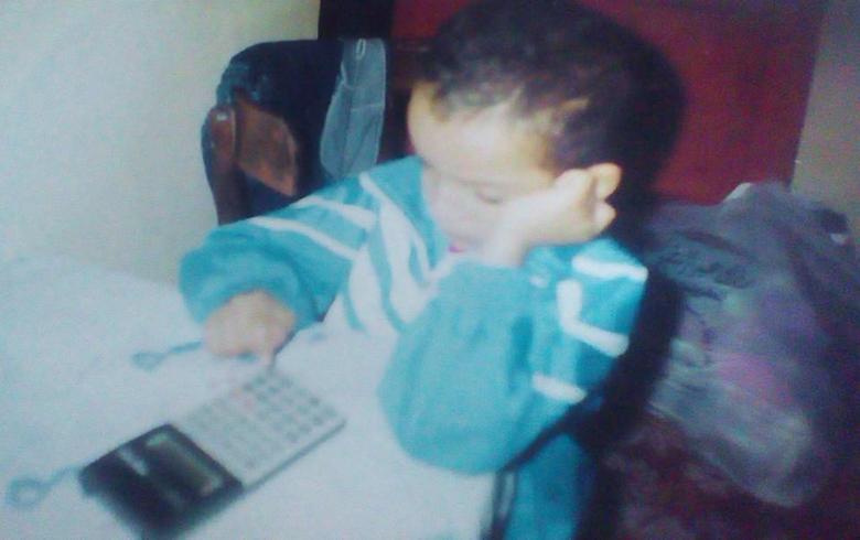 Childhood-era photograph beside a computer