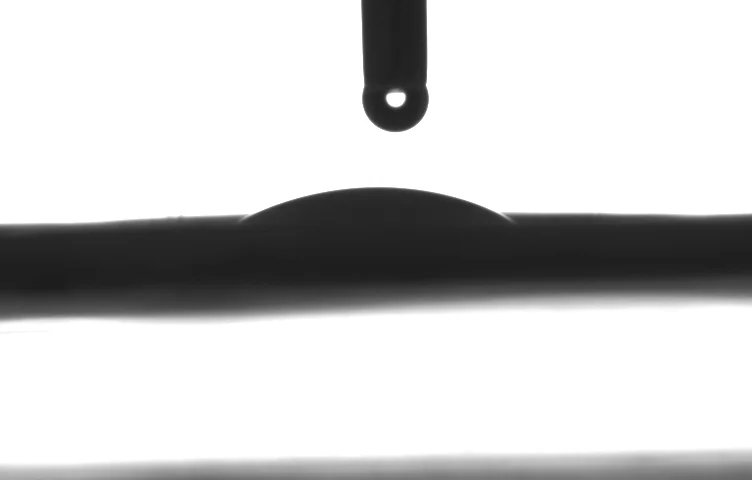 Side-on droplet silhouette labelled W1. No contact-angle value is embedded in the supplied image.