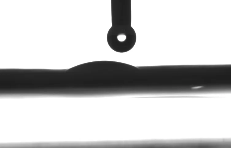 Side-on droplet silhouette labelled W2. No contact-angle value is embedded in the supplied image.